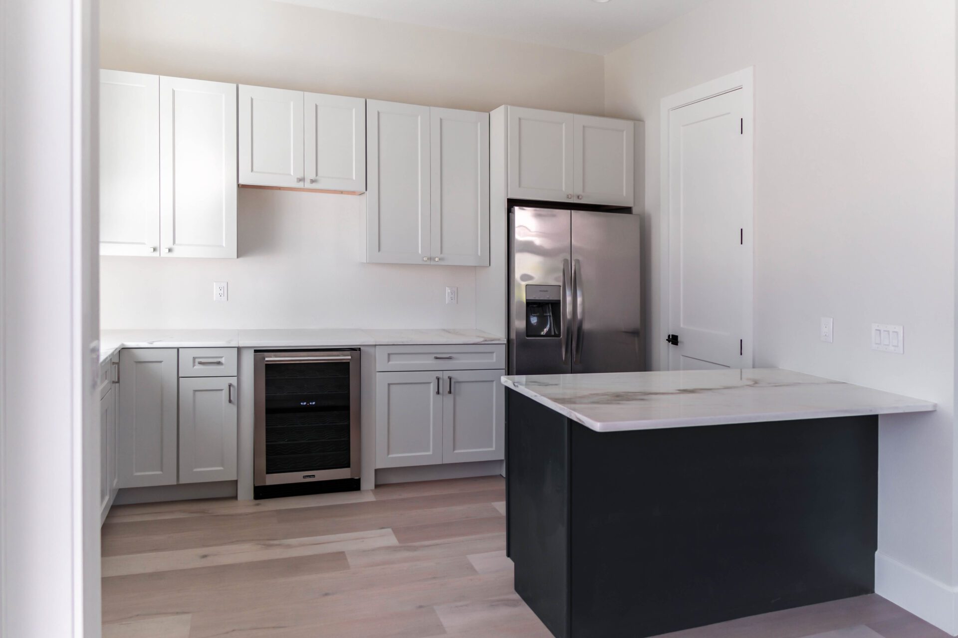 A kitchen with white cupboards